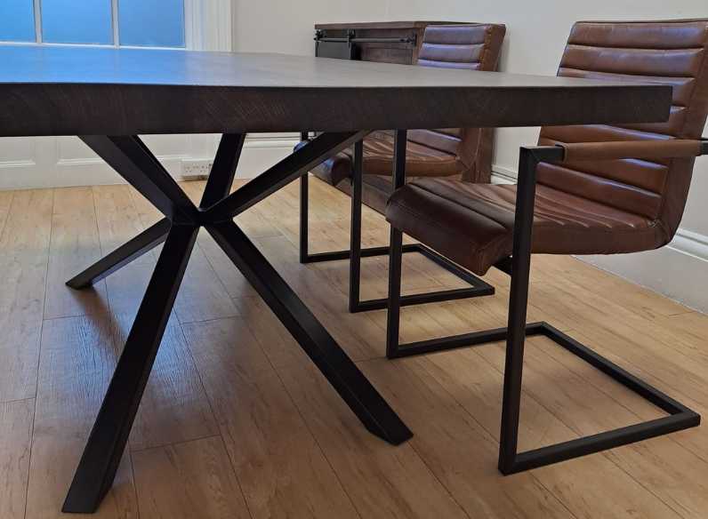 bespoke table with spider leg metal base with a wooden floor